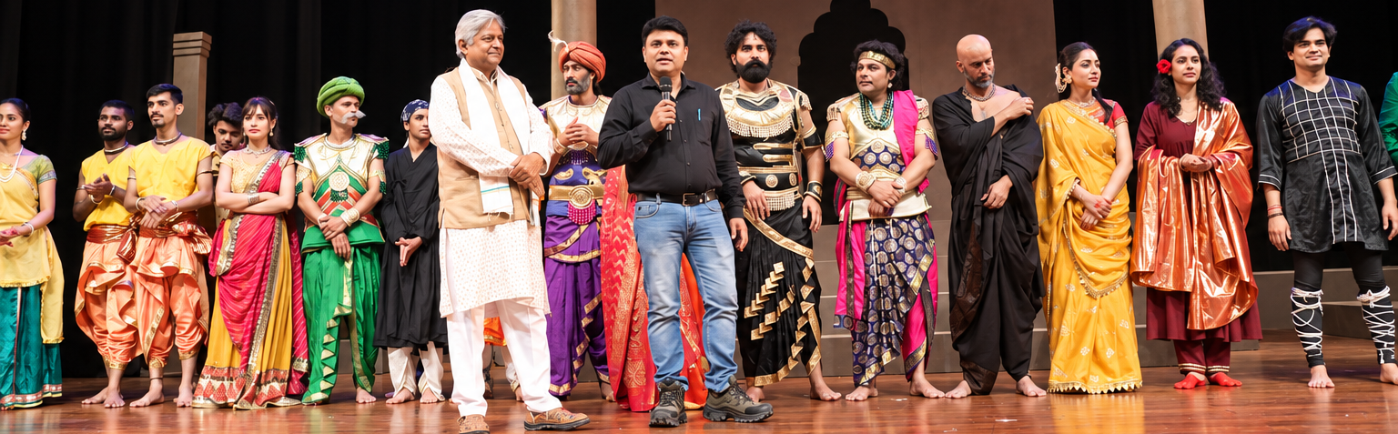 Theatre cast and guests gathered on stage with a speaker addressing the audience