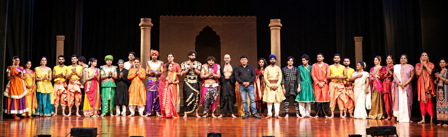 Full theatre cast gathered on stage for a curtain call