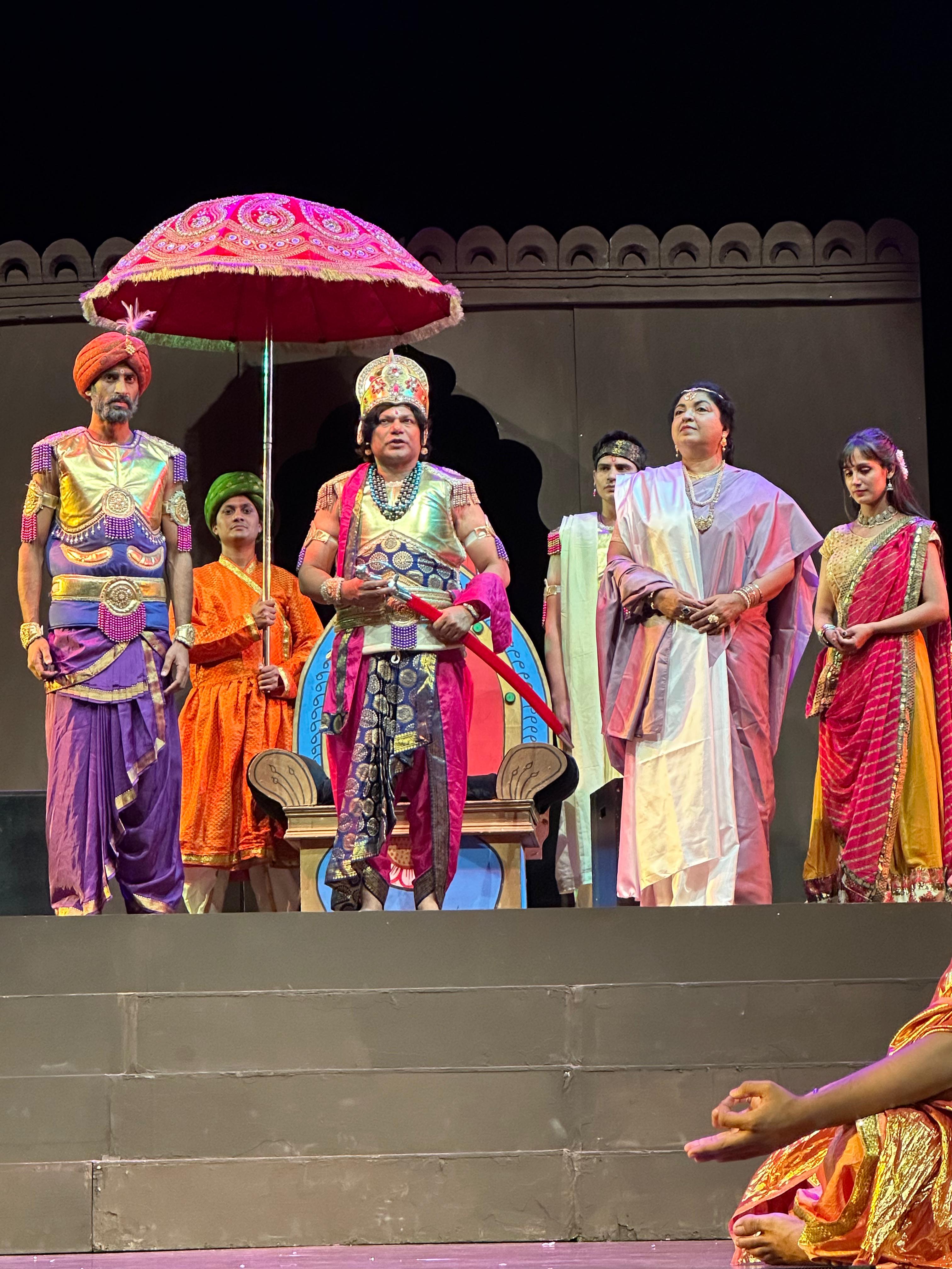 Royal court ensemble beneath a decorative parasol