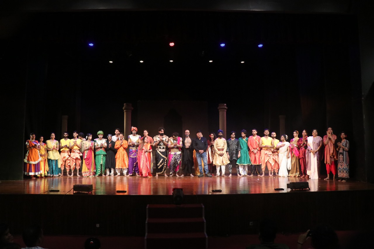 Full cast assembled on stage for a curtain call